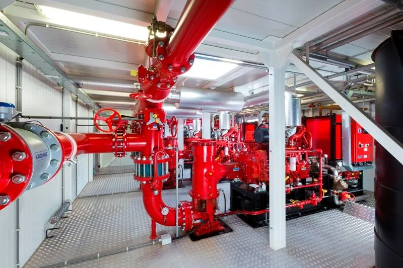 Fire pump room with painted steel riser, control valves and duty pump set