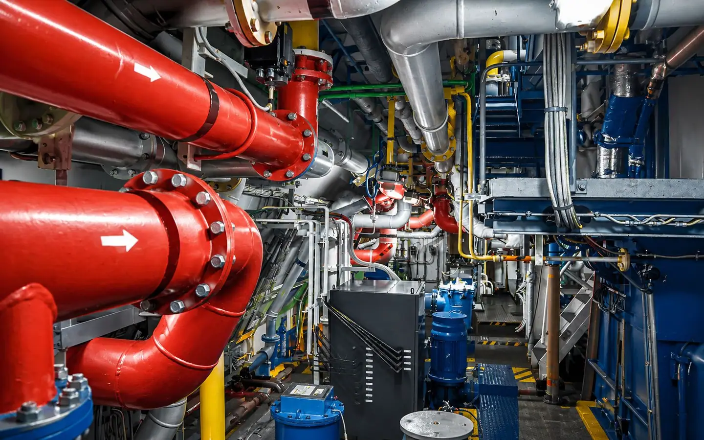 Insulated distribution mains, flanged joints and pumps in a plant room